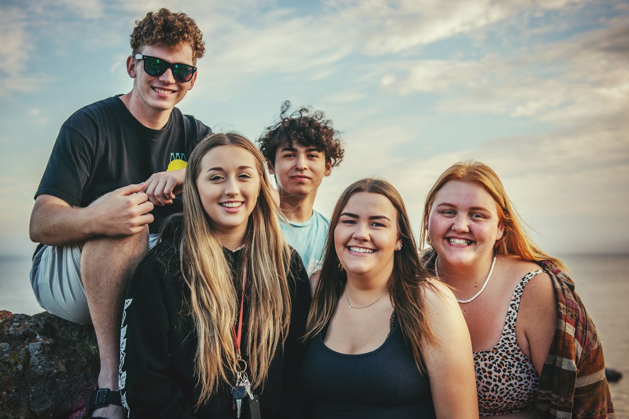 vision Happy young friends posing and smiling together at Avila Beach, California during a sunny day.