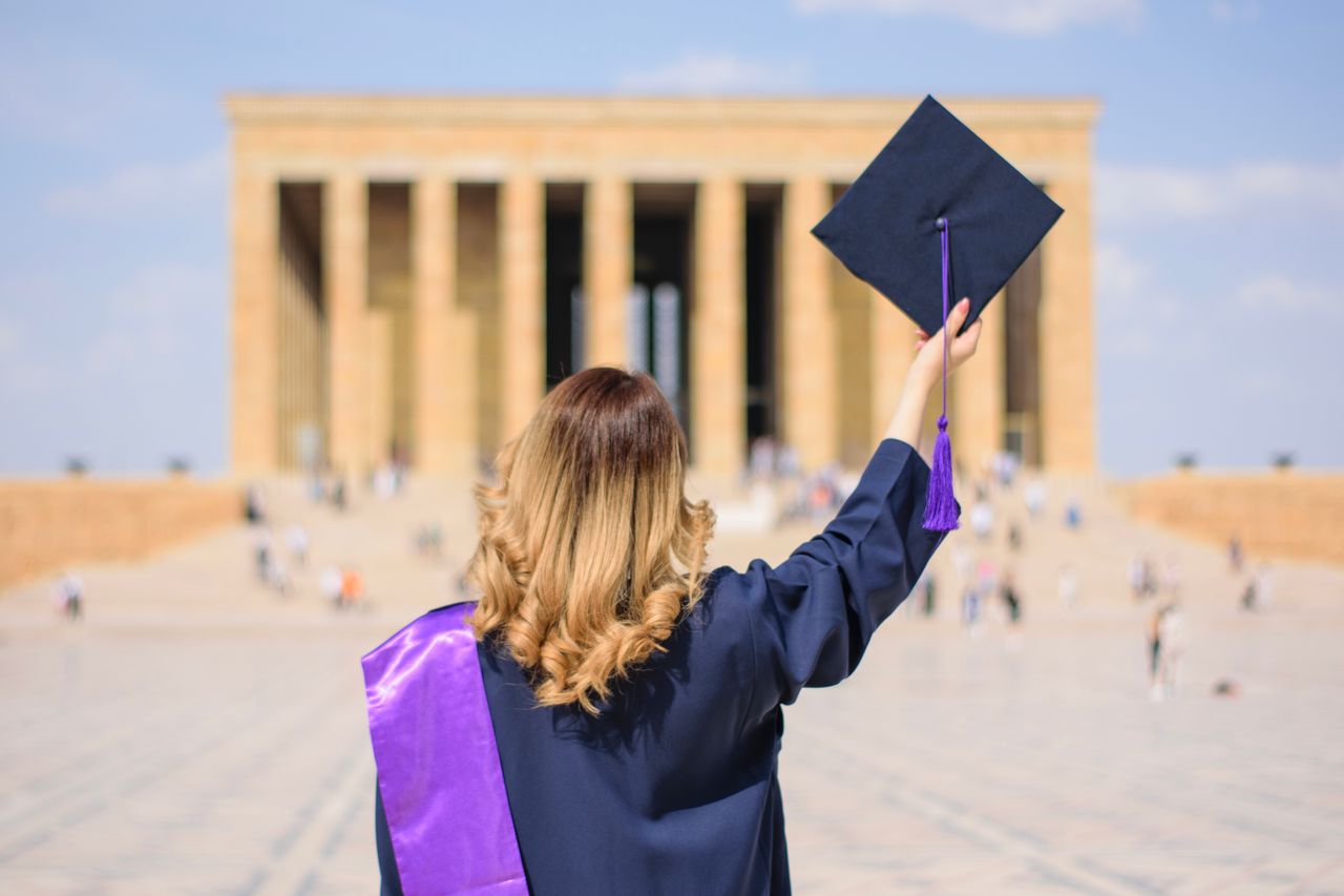 gallery-07 Graduate in cap and gown celebrating achievement at Anitkabir, Ankara.